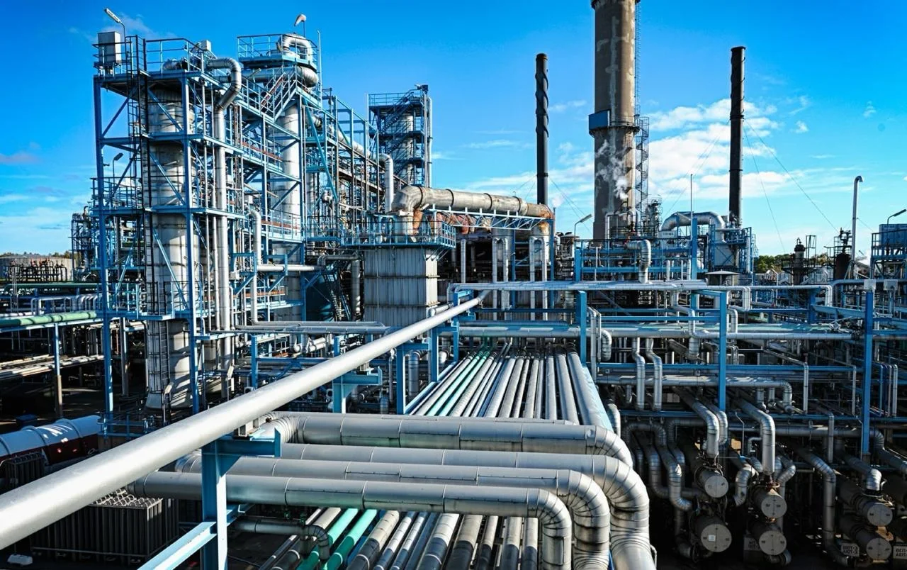 Oil processing facility with process piping, towers and access platforms
