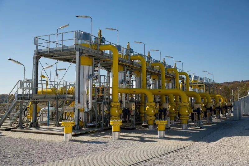 Natural gas station with yellow process piping and elevated access platforms